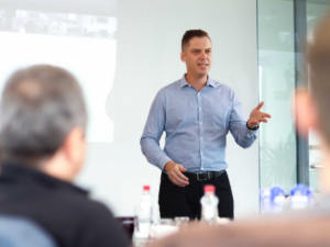Brett Wiskar Speaking to an Executive Audience at a strategy off site retreat